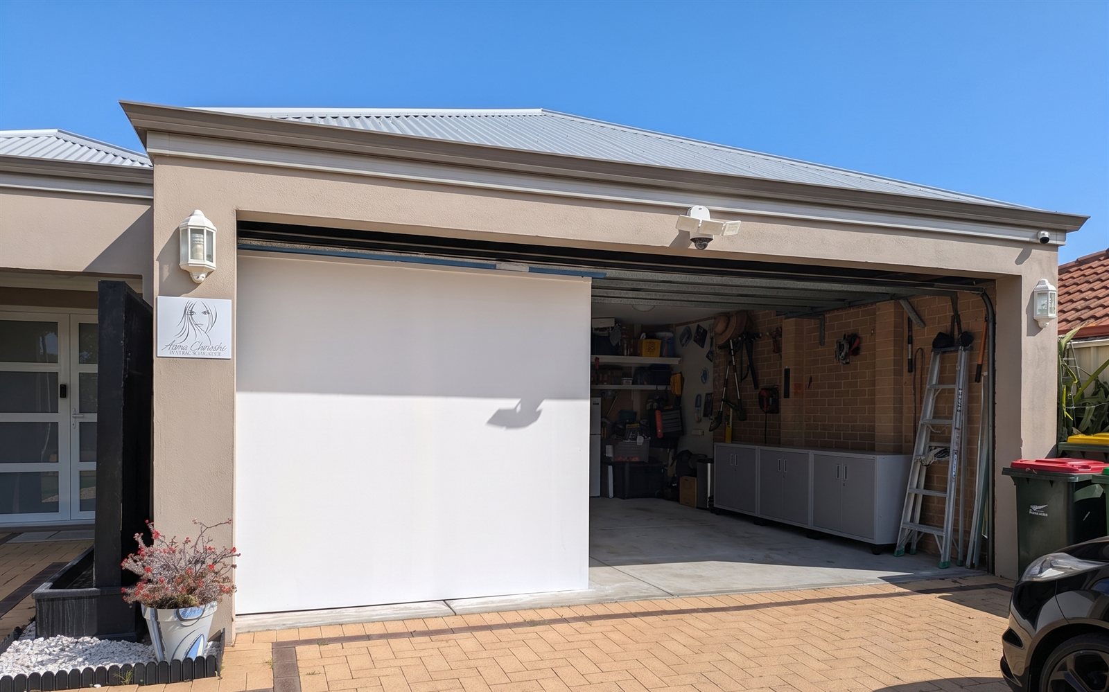 The conversion from outside, while the other half remained available as a single garage.
